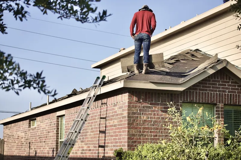 Professional roofer working on a residential roof in Manorville